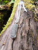 Long Black and white striped beach pebble pendant