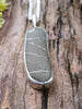 Long Black and white striped beach pebble pendant