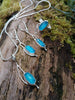 Lantern flower set. Earrings, pendant and ring with sky blue agate rose cut oblong flowers. sitting on a mossy log in the sunshine